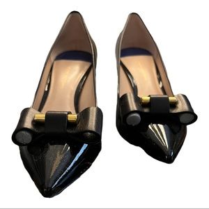 Stuart Weitzman black patent leather pumps with brass detail.  Never worn. Sz 7